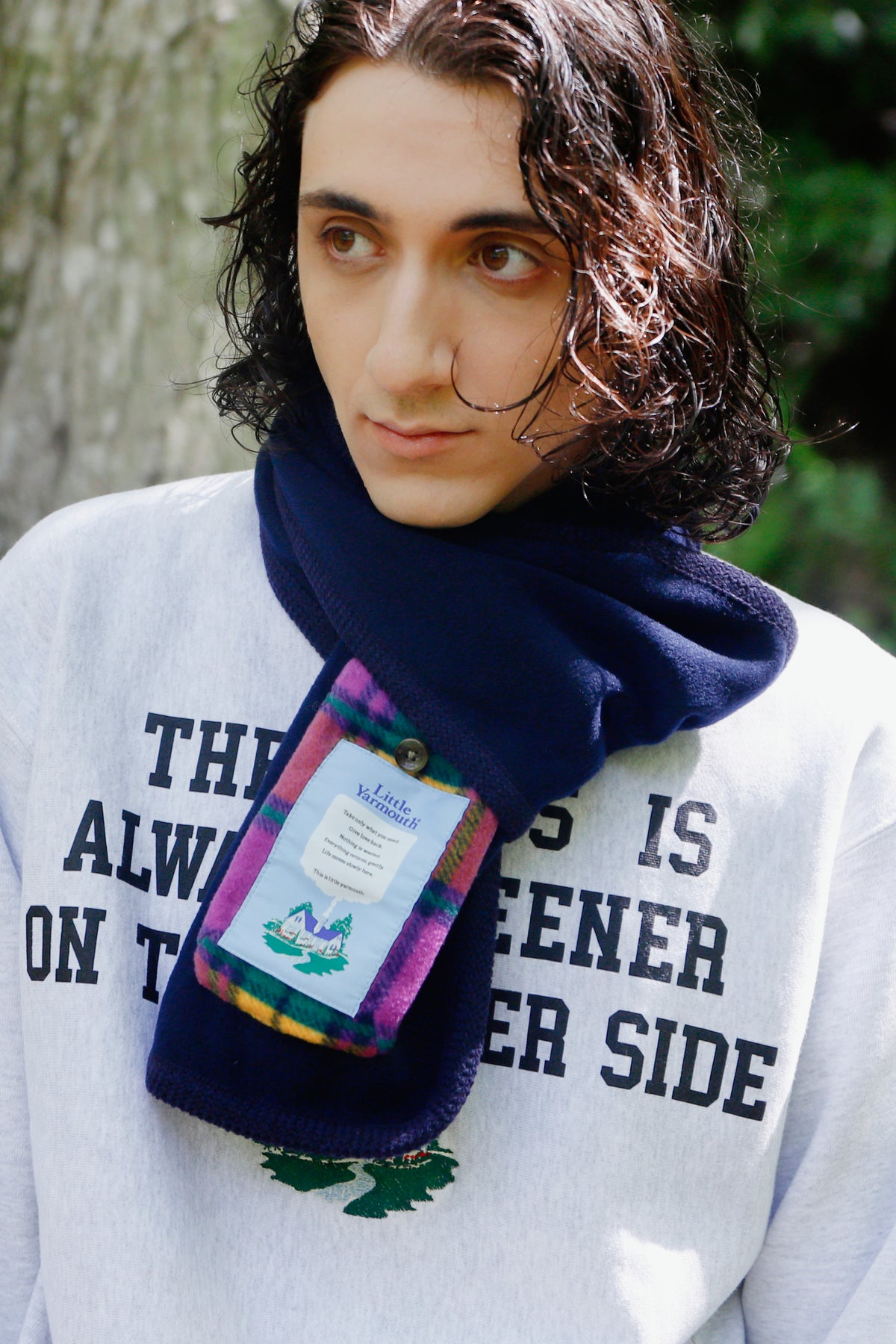 Little Yarmouth EP. 2. A close portrait in a pale sweatshirt and navy scarf with a colorful label.