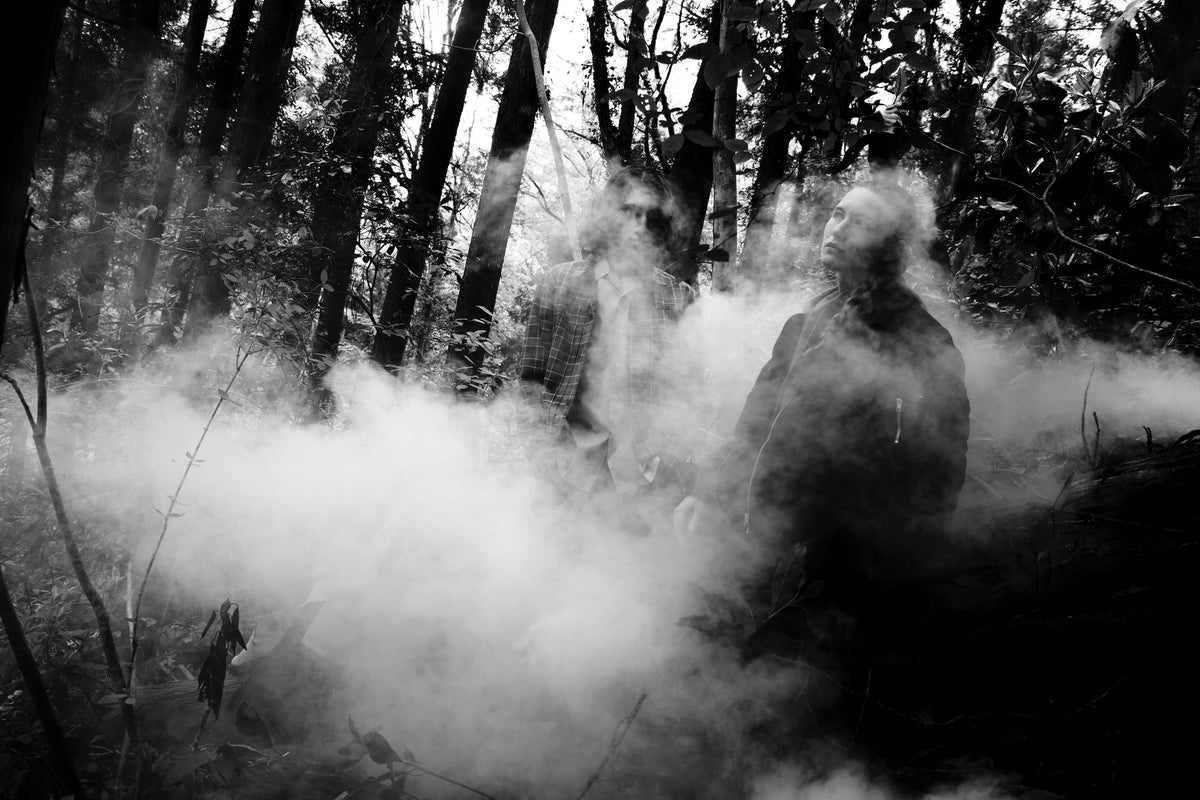 Little Yarmouth EP. 2. A monochrome silhouette walking among trees and drifting mist.
