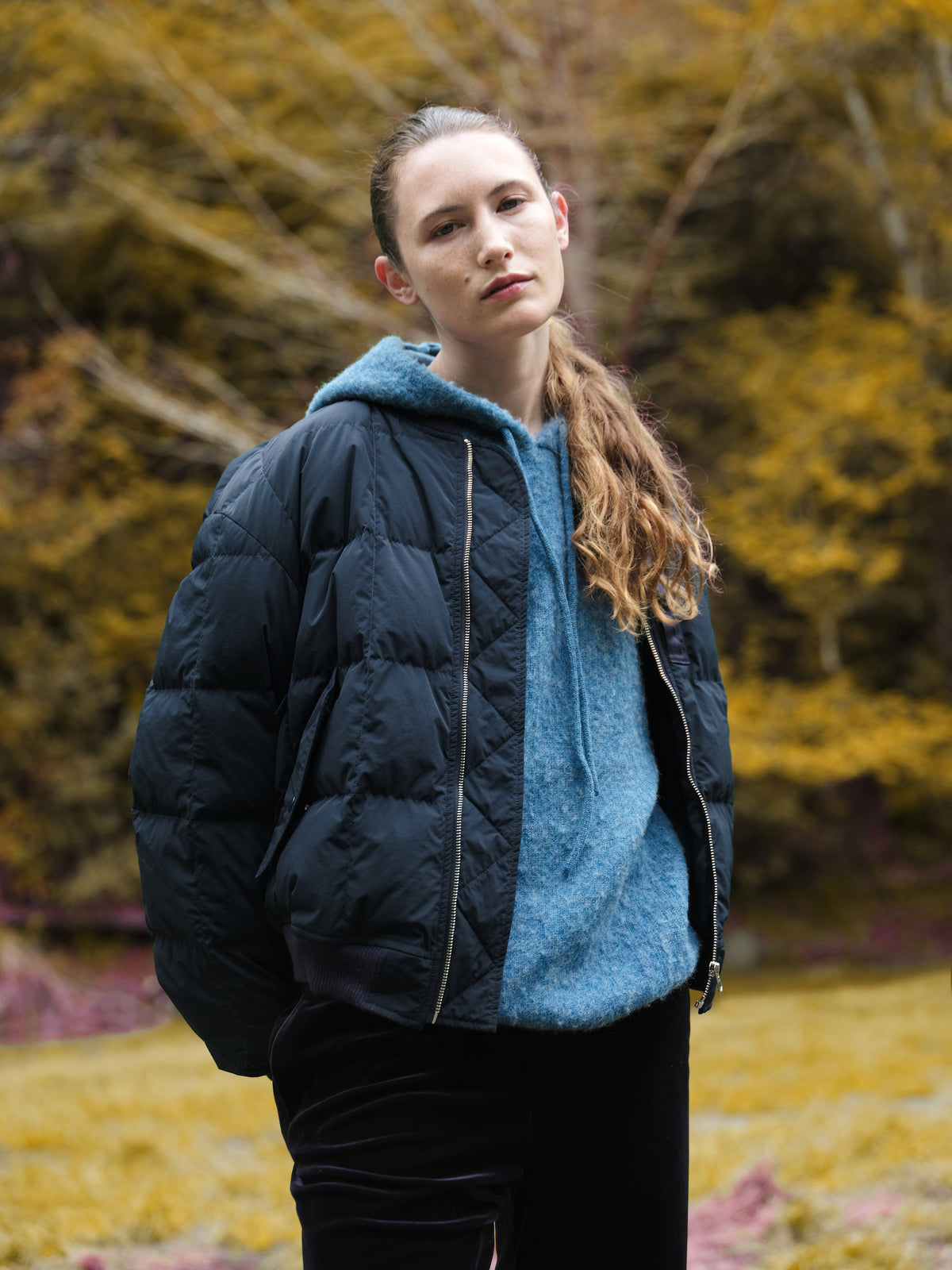 Little Yarmouth EP. 2. A dark quilted jacket layered over a blue fleece against golden foliage.