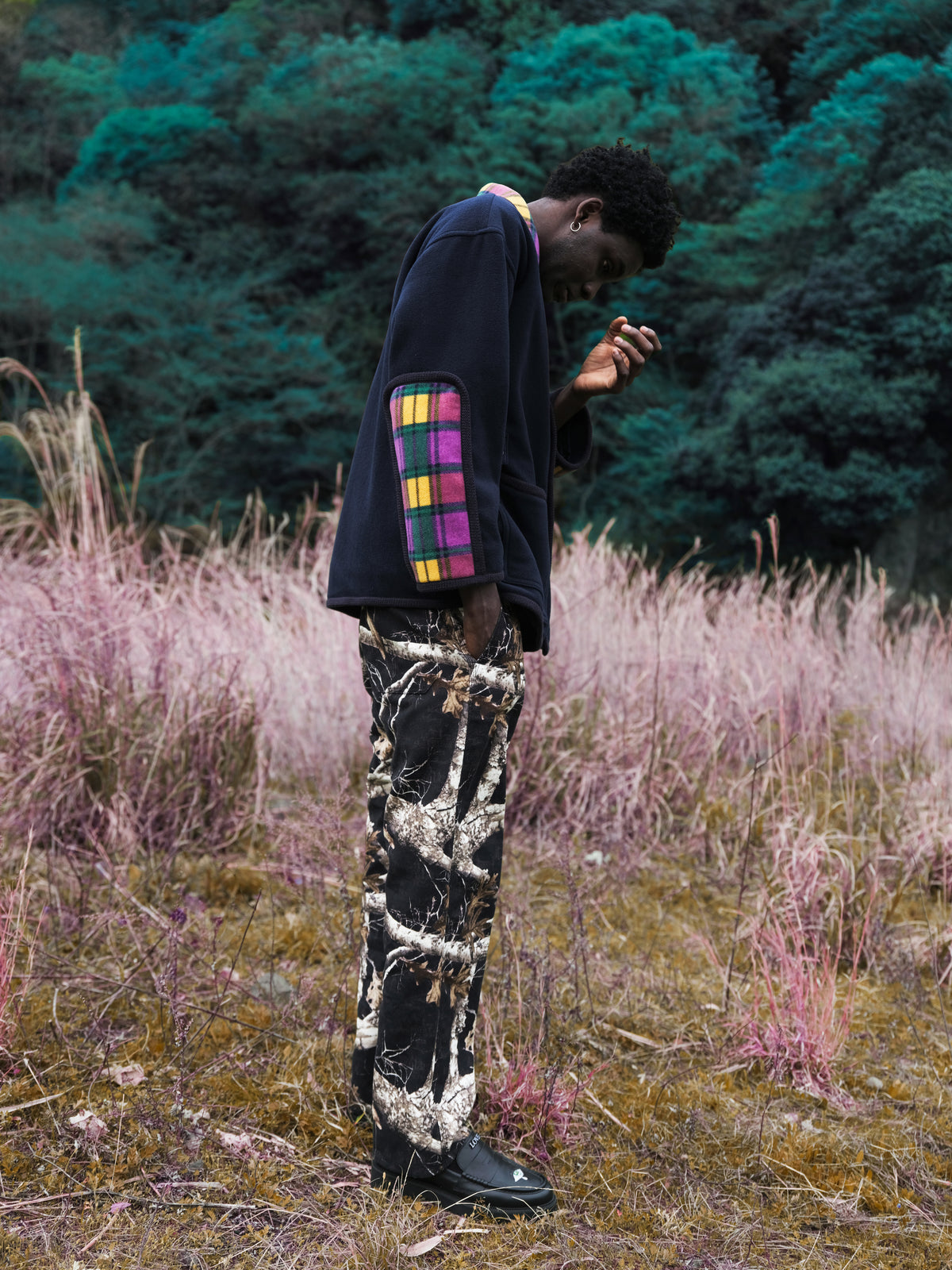 Little Yarmouth EP. 2. A dark jacket with a colorful sleeve panel beside pink grasses.