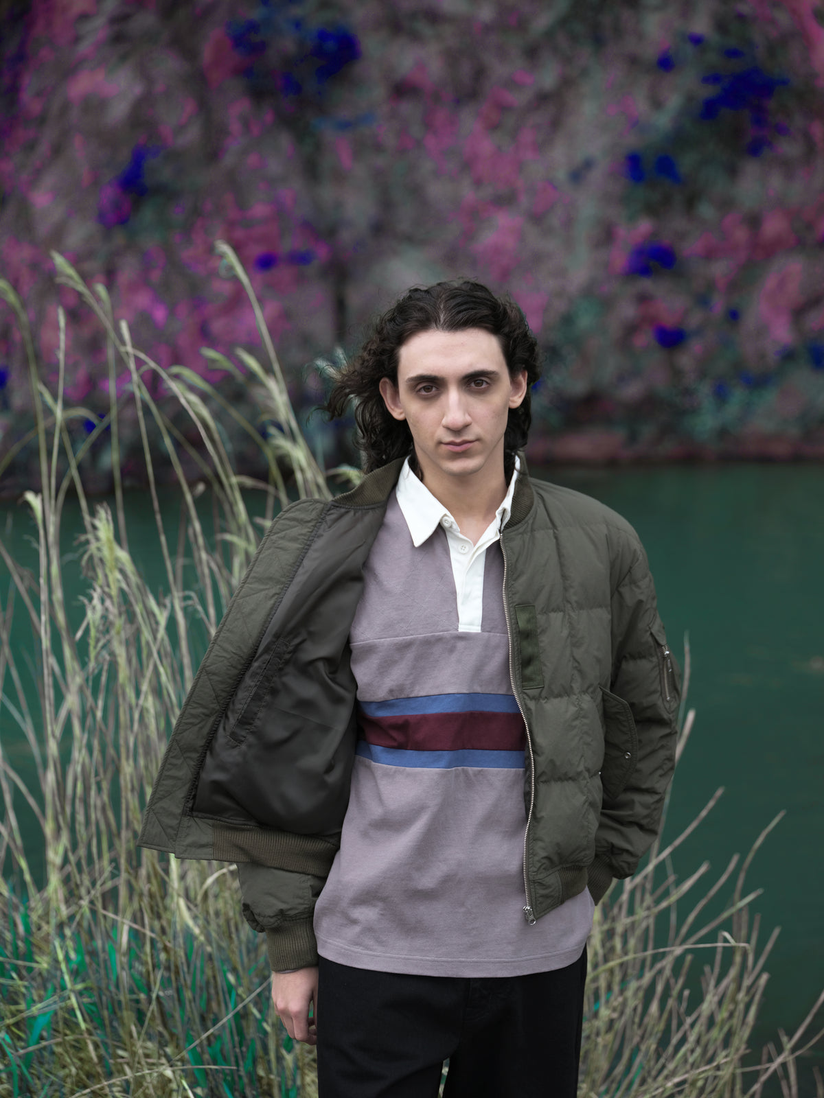 Little Yarmouth EP. 2. An olive jacket and color-block rugby shirt beside a green river.