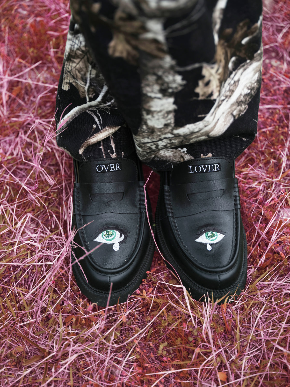 Little Yarmouth EP. 2. Patterned trousers and illustrated black shoes on pink grass.