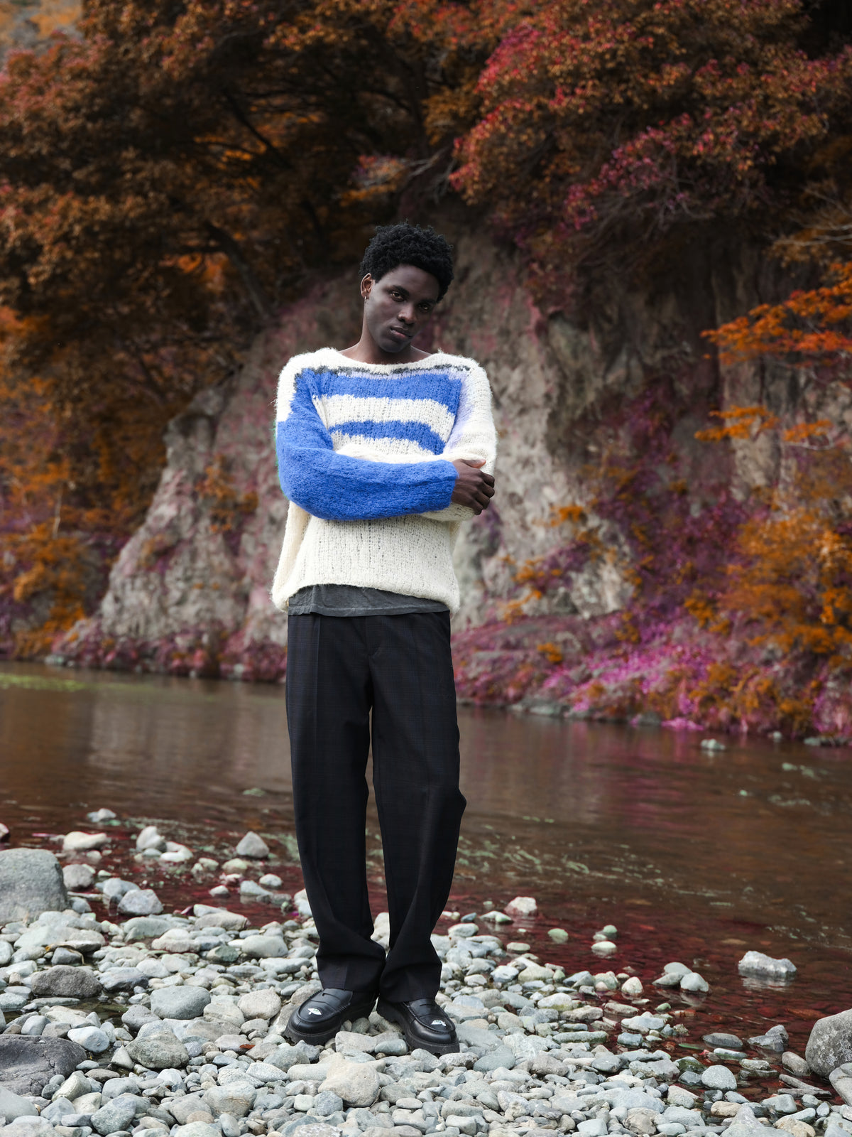 Little Yarmouth EP. 2. A white and blue knit against autumn trees by the river.