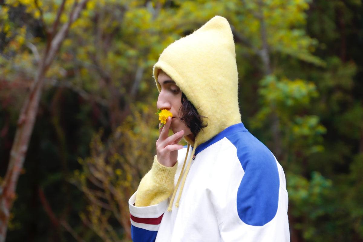 Little Yarmouth EP. 2. A yellow hood and a small flower against golden trees.